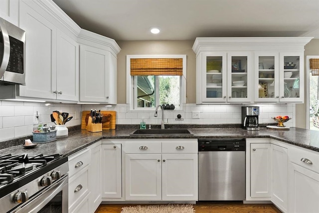 996A Basin Rd, Colville, WA 99114 - kitchen with appliances with stainless steel finishes, white cabinetry, and backsplash