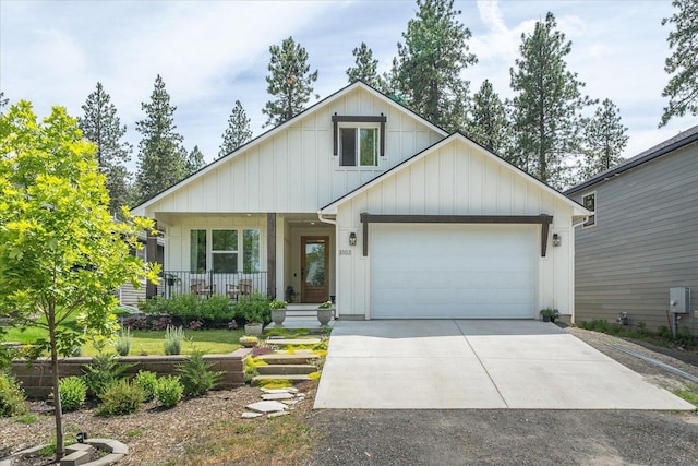3103 W 18th Ave, Spokane, WA 99224 - view of front of home featuring a garage, driveway, a porch, and board and batten siding