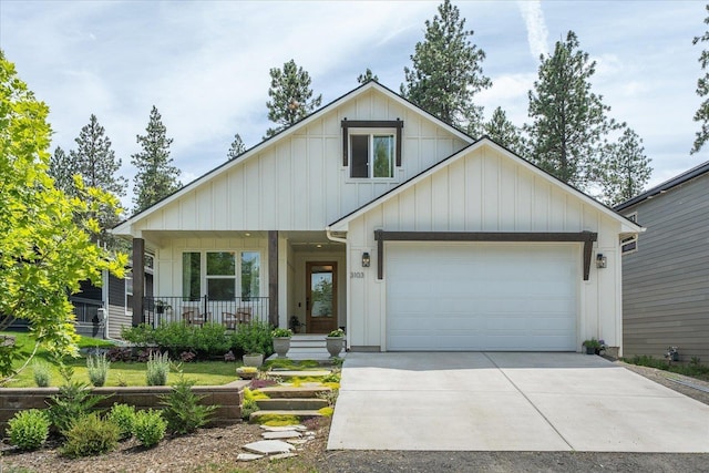 3103 W 18th Ave, Spokane, WA 99224 - view of front of property with covered porch, board and batten siding, an attached garage, and concrete driveway
