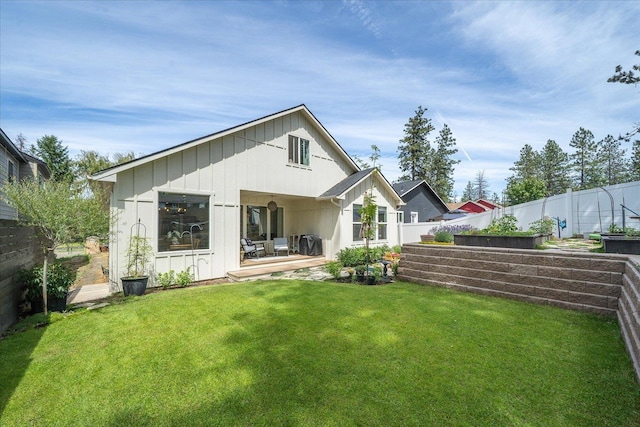 3103 W 18th Ave, Spokane, WA 99224 - back of property featuring a vegetable garden, board and batten siding, and a patio