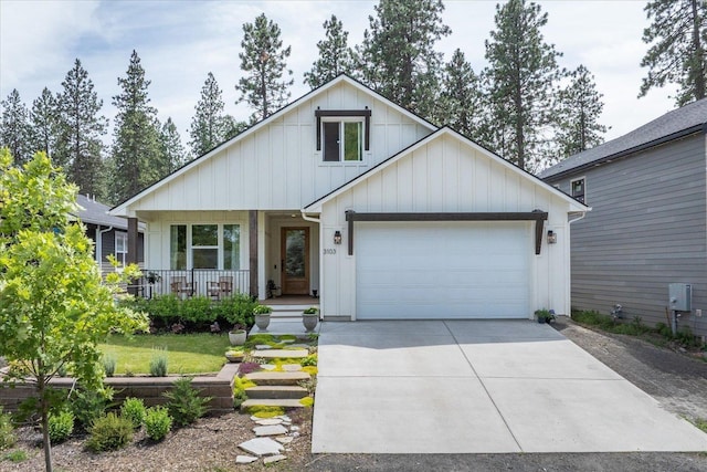 3103 W 18th Ave, Spokane, WA 99224 - view of front of house featuring a porch, board and batten siding, concrete driveway, and an attached garage