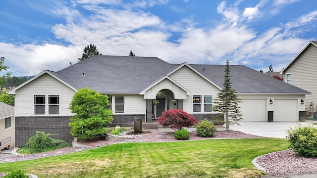 2716 S Man O War Ln, Veradale, WA 99037 - view of front of property featuring brick siding, an attached garage, driveway, and a front yard
