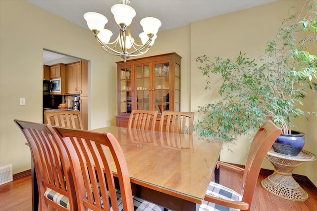 2716 S Man O War Ln, Veradale, WA 99037 - dining area featuring a chandelier and wood finished floors