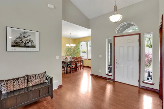 2716 S Man O War Ln, Veradale, WA 99037 - foyer entrance featuring high vaulted ceiling, wood finished floors, and a chandelier