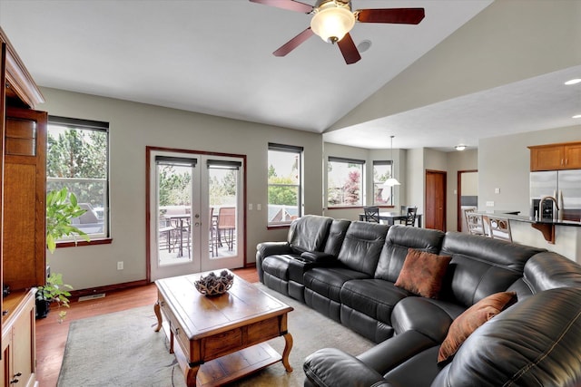 2716 S Man O War Ln, Veradale, WA 99037 - living area with healthy amount of natural light, light wood-style floors, ceiling fan, vaulted ceiling, and french doors