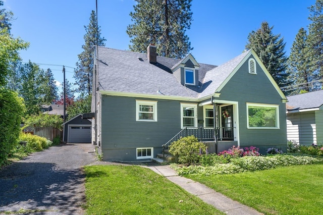 1123 W 25th Ave, Spokane, WA 99203 - view of front facade featuring driveway, a front yard, a chimney, and an outdoor structure