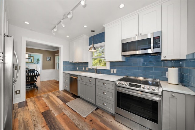 1123 W 25th Ave, Spokane, WA 99203 - kitchen featuring appliances with stainless steel finishes, light countertops, gray cabinets, wainscoting, and white cabinetry