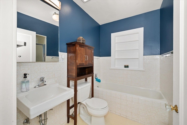 1123 W 25th Ave, Spokane, WA 99203 - full bathroom featuring tile walls, a garden tub, wainscoting, and a shower