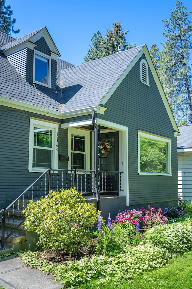1123 W 25th Ave, Spokane, WA 99203 - view of front of property featuring stairway, covered porch, and roof with shingles