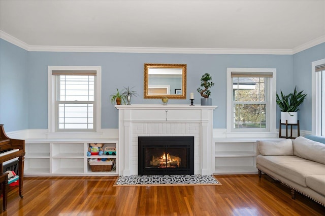 1123 W 25th Ave, Spokane, WA 99203 - living area with wood finished floors, a brick fireplace, and ornamental molding