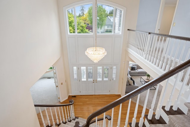 1714 E S Ridge Dr, Spokane, WA 99223 - entrance foyer featuring wood finished floors, a chandelier, a towering ceiling, stairway, and a decorative wall