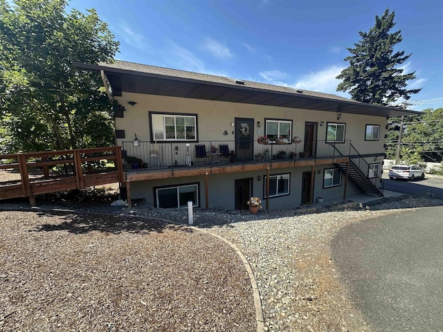 360 E 7th Ave # B, Colville, WA 99114 - view of front facade featuring stucco siding and stairway