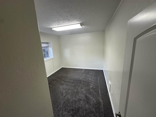 360 E 7th Ave # B, Colville, WA 99114 - empty room featuring a textured ceiling, dark colored carpet, and a textured wall