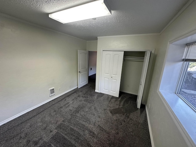 360 E 7th Ave # B, Colville, WA 99114 - unfurnished bedroom with dark colored carpet, a textured ceiling, a closet, and crown molding