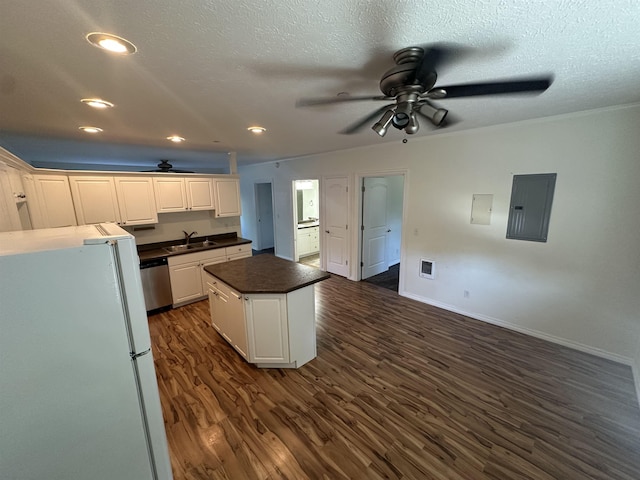 360 E 7th Ave # B, Colville, WA 99114 - kitchen with freestanding refrigerator, a ceiling fan, electric panel, stainless steel dishwasher, and a center island