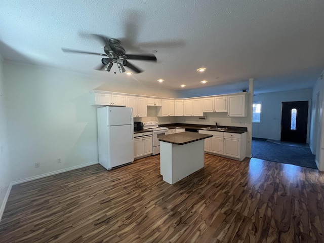 360 E 7th Ave # B, Colville, WA 99114 - kitchen featuring white appliances, dark countertops, dark wood finished floors, white cabinets, and recessed lighting