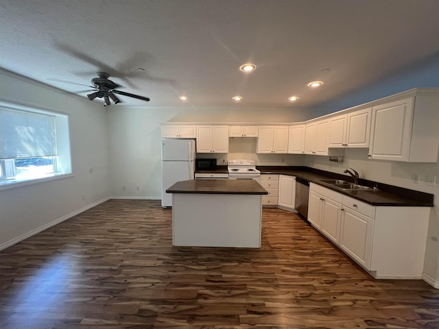360 E 7th Ave # B, Colville, WA 99114 - kitchen with white appliances, dark wood finished floors, a center island, ceiling fan, and dark countertops