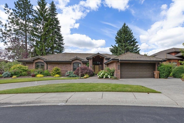 5430 S Quail Ridge Cir, Spokane, WA 99223 - view of front of house featuring a tile roof, an attached garage, and driveway