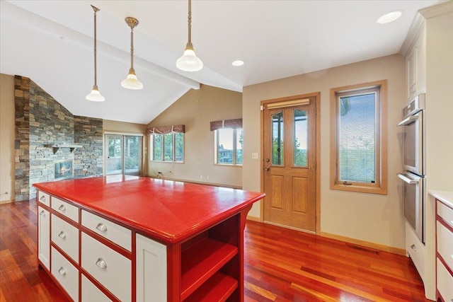 5430 S Quail Ridge Cir, Spokane, WA 99223 - kitchen with double oven, dark wood finished floors, white cabinetry, and decorative light fixtures