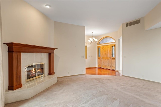 5430 S Quail Ridge Cir, Spokane, WA 99223 - unfurnished living room with a chandelier, carpet flooring, and a tiled fireplace