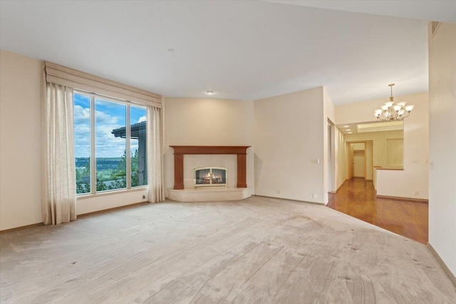 5430 S Quail Ridge Cir, Spokane, WA 99223 - unfurnished living room featuring a chandelier, a high end fireplace, carpet flooring, and wood finished floors