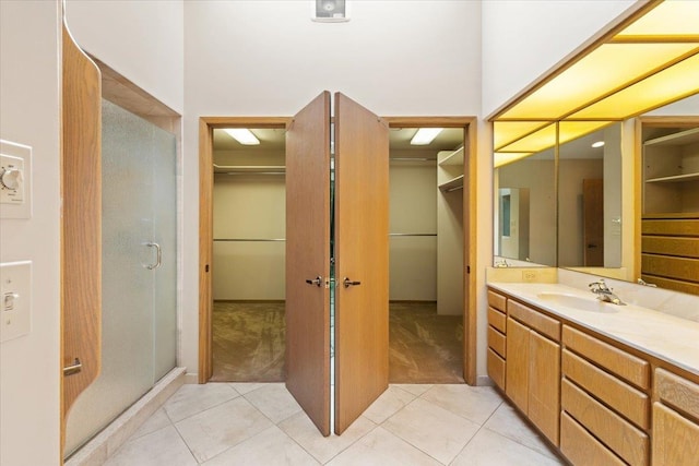 5430 S Quail Ridge Cir, Spokane, WA 99223 - full bathroom with a stall shower, vanity, a spacious closet, and tile patterned flooring