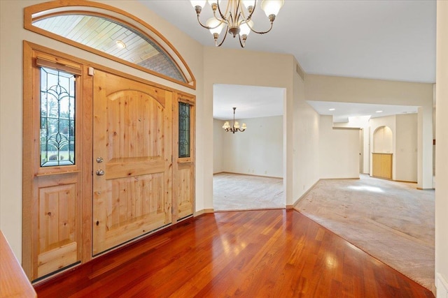 5430 S Quail Ridge Cir, Spokane, WA 99223 - carpeted foyer entrance with a chandelier, wood finished floors, and arched walkways