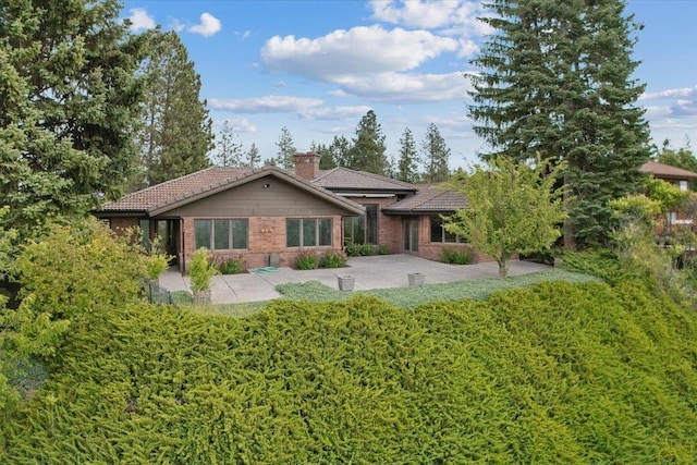5430 S Quail Ridge Cir, Spokane, WA 99223 - single story home with a tile roof, a chimney, and a patio