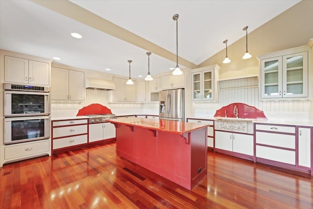 5430 S Quail Ridge Cir, Spokane, WA 99223 - kitchen featuring stainless steel appliances, custom exhaust hood, dark wood-style floors, tasteful backsplash, and lofted ceiling
