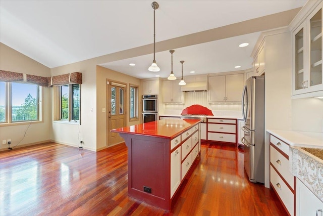 5430 S Quail Ridge Cir, Spokane, WA 99223 - kitchen with stainless steel appliances, dark wood finished floors, glass insert cabinets, a kitchen island, and pendant lighting