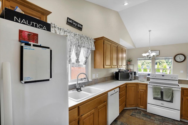 15418 E 24th Ave, Spokane Valley, WA 99037 - kitchen with white appliances, a chandelier, vaulted ceiling, light countertops, and decorative light fixtures