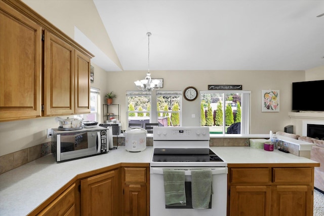 15418 E 24th Ave, Spokane Valley, WA 99037 - kitchen with electric range, a peninsula, light countertops, a chandelier, and vaulted ceiling