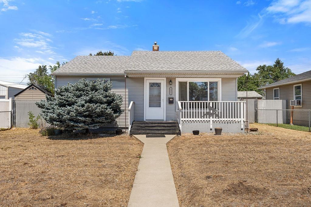 1311 E Garland Ave, Spokane, WA 99207 - bungalow-style house with a chimney, covered porch, and cooling unit
