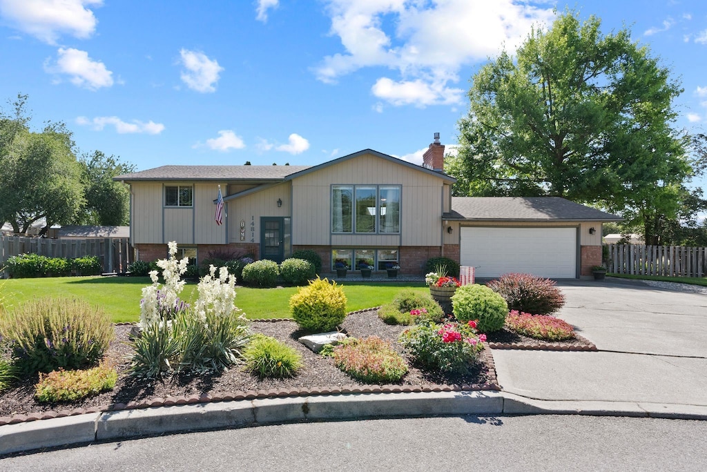 14814 E Alki Ave, Spokane Valley, WA 99216 - view of front of property featuring brick siding, driveway, an attached garage, and a chimney