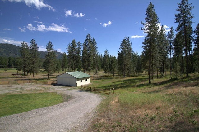 1425 N Chapin Rd, Evans, WA 99126 - view of dirt / gravel driveway with a rural view, an outbuilding, a view of trees, and a mountain view
