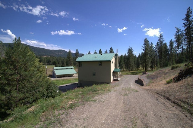 1425 N Chapin Rd, Evans, WA 99126 - view of dirt / gravel driveway featuring a mountain view and a wooded view