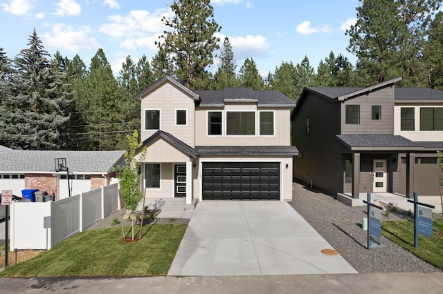1215 S Radio Ln, Spokane Valley, WA 99212 - view of front facade with a garage, driveway, board and batten siding, and roof with shingles