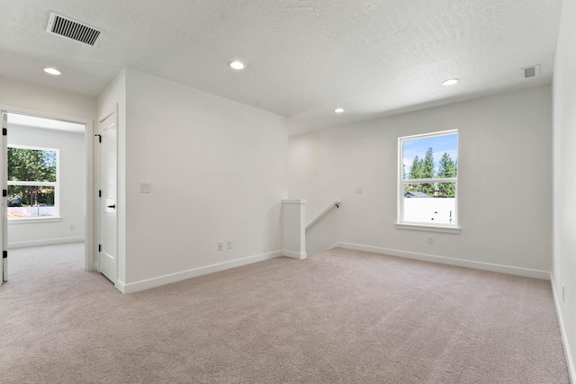 1215 S Radio Ln, Spokane Valley, WA 99212 - unfurnished room with healthy amount of natural light, light colored carpet, recessed lighting, and a textured ceiling
