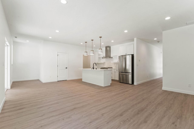 1215 S Radio Ln, Spokane Valley, WA 99212 - kitchen with freestanding refrigerator, open floor plan, recessed lighting, wall chimney exhaust hood, and light wood-style floors