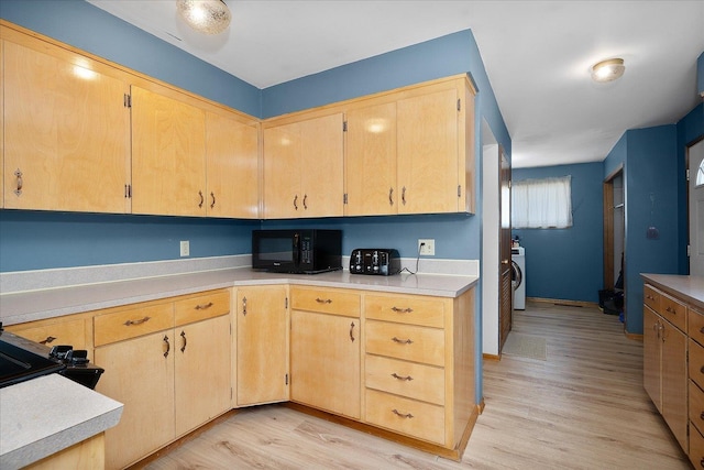 40010 N Newport Hwy, Elk, WA 99009 - kitchen with black microwave, light wood-style floors, light countertops, and light brown cabinetry