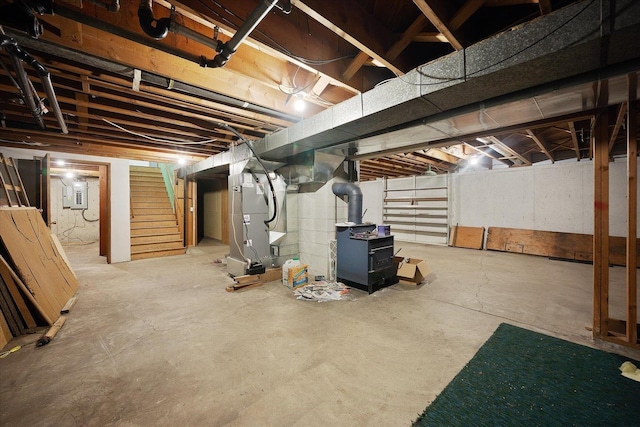 40010 N Newport Hwy, Elk, WA 99009 - unfinished below grade area with heating unit, stairs, and electric panel