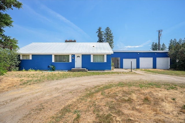 40010 N Newport Hwy, Elk, WA 99009 - single story home with a garage, a metal roof, dirt driveway, and an outdoor structure