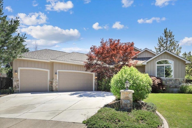 3405 W Kens Ct, Spokane, WA 99208 - view of front of house with a garage, concrete driveway, board and batten siding, and stone siding