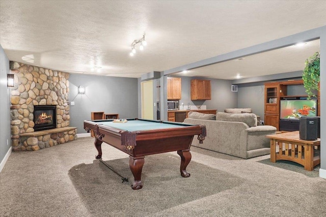 3405 W Kens Ct, Spokane, WA 99208 - playroom featuring carpet flooring, a stone fireplace, a textured ceiling, and pool table