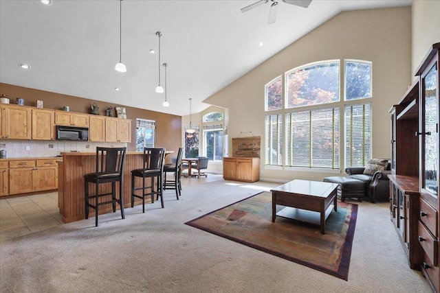 3405 W Kens Ct, Spokane, WA 99208 - living room with light colored carpet, high vaulted ceiling, ceiling fan, and recessed lighting