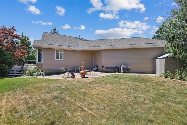 3405 W Kens Ct, Spokane, WA 99208 - rear view of property featuring a patio area, a wooden deck, a storage unit, and a yard