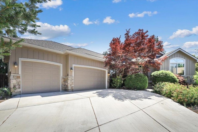 3405 W Kens Ct, Spokane, WA 99208 - view of front of home featuring an attached garage, stone siding, board and batten siding, and concrete driveway