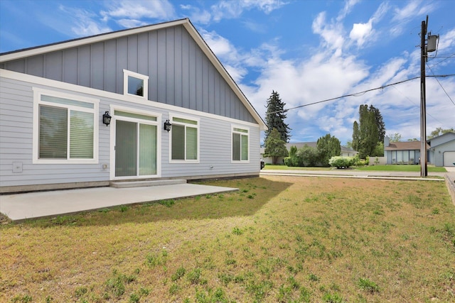 403 N Calvin Ln, Spokane Valley, WA 99216 - back of house featuring board and batten siding, a patio area, and a yard