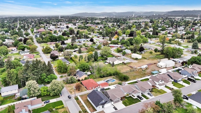 403 N Calvin Ln, Spokane Valley, WA 99216 - aerial overview of property's location featuring a mountain backdrop and nearby suburban area