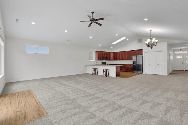 403 N Calvin Ln, Spokane Valley, WA 99216 - unfurnished living room featuring a chandelier, ceiling fan, light colored carpet, high vaulted ceiling, and recessed lighting